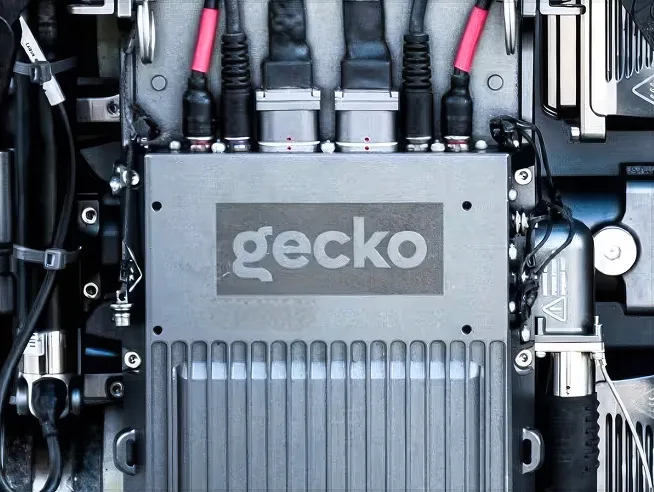 A Gecko Robotics electronics module on an inspection robot, with cables plugged in
